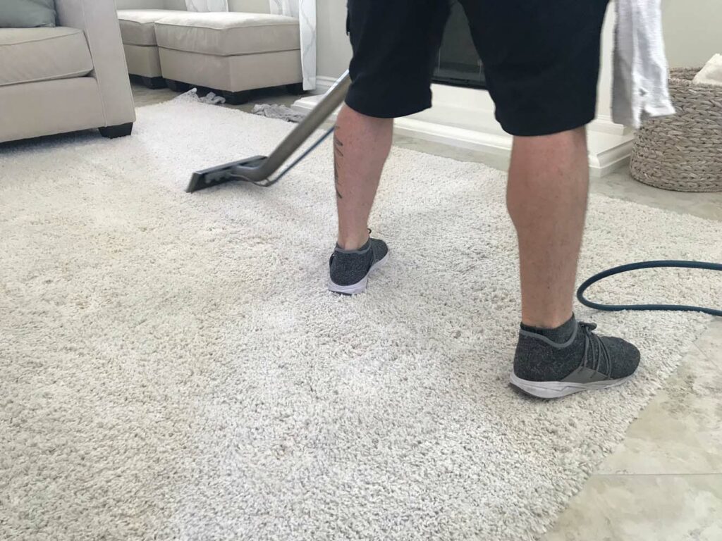 a-man-is-shampooing-a-white-rug-to-remove-stains-a-2022-10-31-23-35-41-utc